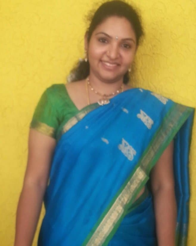 Srividya smiling in a blue saree, early in her journey